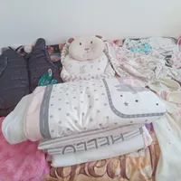تعداد زیادی لباس  وسایل خواب نوزاد