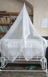 گهواره فلزی کنار تخت