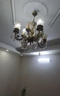 ست لوستر ۸ شاخه برنجی و ساعت مدل خورشیدی