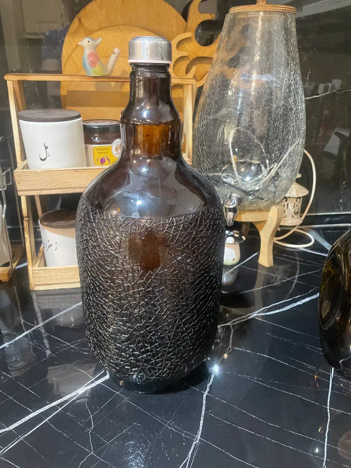 تعدادی بطری شیشه ای در دار|ظروف سرو و پذیرایی|مشهد, نیروی هوایی|دیوار