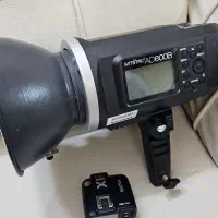 پرتابل گودکس ad600b همراه تریگر و پایه و کیف چرمی