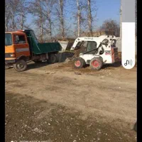 حمل نخاله توسط کارگروبابکت بیل مکانیکی