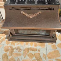 بخاری گازی طرح شومینه قهوه‌ای دودکش‌دار