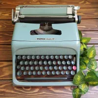 دستگاه تایپ قدیمی فارسی فیروزه‌ای