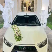ماشین عروس دنا پلاس سفید با گل فقط۳،۵۰۰،۰۰۰