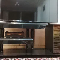 میز تلویزیون مشکی شیشه ای سه کشو ام دی اف