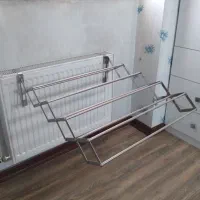 رخت آویز استیل آکاردئونی تاشو نصب روی شوفاژ دیوار