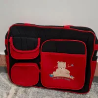 ساک نوزادی قرمز مشکی کاملا سالم و تمیز