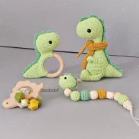 عروسک بافتنی جغجغه بندپستونک طرح دایناسور