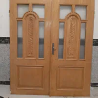 درب دولنگه چوب کارشده همراه باچهارچوب اهنی سنگین
