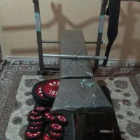 پرس سینه چند کاره به همراه وزنه و هارتل و دمبل