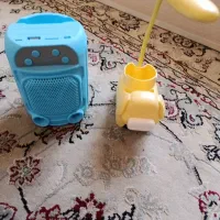 کیف و اسپیکر و دسته بدمینتون و جامدادی و چراغ خواب