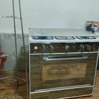 اجاق گاز پنج شعله همراه با جا قابلمه ی میله ای
