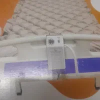 دستگاه ساکشن و تخت بیمار بهمراه تشک مواج