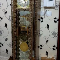 اینه همراه شمعدان و ساعت ایستاده و ویترین برنز