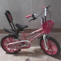 دوچرخه دخترانه سایز ۱۶ صورتی با چرخ کمکی