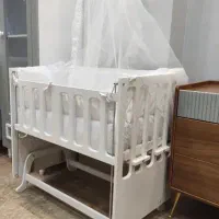 تخت کودک دو منظوره نو همراه با پشه بند و تشک بالش