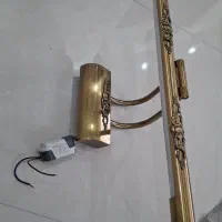 چراغ بالای تابلوی فلزی طلایی