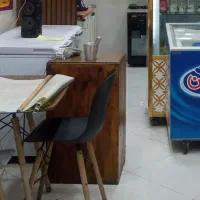 میز پاچال تک کشو و تعدادی لیوان کافی شاپی