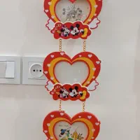 ساعت دیواری با دو قاب عکس