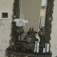 میز کنسول اینه همراه با ساعتش و شمع دونه ها