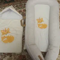 رختخواب و قنداقی نوزاد