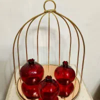 قفس فلزی طلایی با انار های شیشه ای