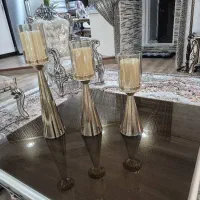 جا شمعی طلایی با شمع داخلش