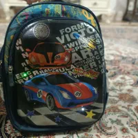 کوله پشتی چراغ دار مدرسه|کیف، کفش، کمربند|رشت, کوی قدس|دیوار