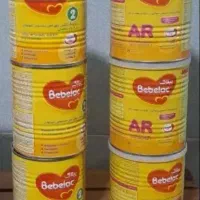 قوطی شیر خشک به همراه قاشق و درب