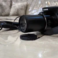 Canon sx60 دوربین عکاسی همراه سه پایه