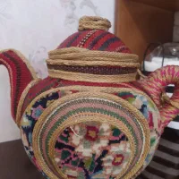 قوری سفالی و  گلیم کارشده و فرش