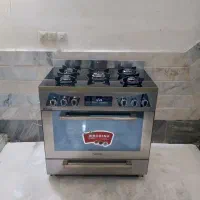 فرگاز صفحه شیشه ای بدنه استیل فول آپشن پنل لمسی