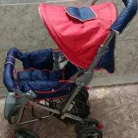 کالسکه ی بچه رنگ قرمز سورمه ای تمیز