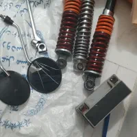 سه عدد کمک فنر هندا یک جفت آینه و باطری هندا