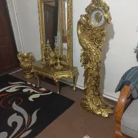 اینه و شمعدان با گلدان و ساعت ایستاده