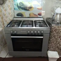 اجاق گاز تمام استیل دارای فر و جوجه گردان