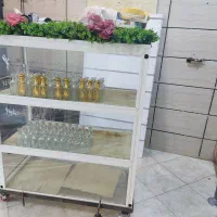 تعداد صد عطر شیشه همراه یک عدد ویترین چرخ المینوم
