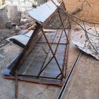 نرده حفاظ روی دیوار و سر درب فلزی روی درب حیاط