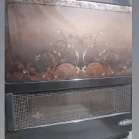 بخاری گازی و کرسی چوبی