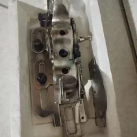 دستگاه برقی چرخ قدیمی و جا دکمه زن