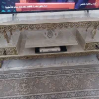 ساعت و میز تلویزیون و آینه شمعدان و بوفه برنجی