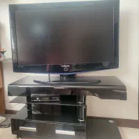 تلویزیون  به همراه میز تلویزیون