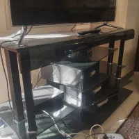 میز تلوزیون شیشه ای ۳تا کشو چوبی در حد نو