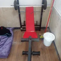 میز ورزش در حد نو با ۱۶ کیلو وزنه