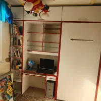 تخت تاشو به همراه کتابخانه و میز کامپیوتر و دکور