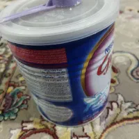قوطی شیر خشک همراه با قاشق و درپوش سفت