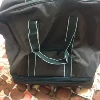 یک عدد ساک مسافرتی بزرگ چرخ دار