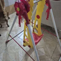 یک عدد صندلی بچه و سر سره و صندلی غذاخوری بچه و