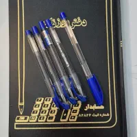 دفتر روزنامه و خودکار آبی